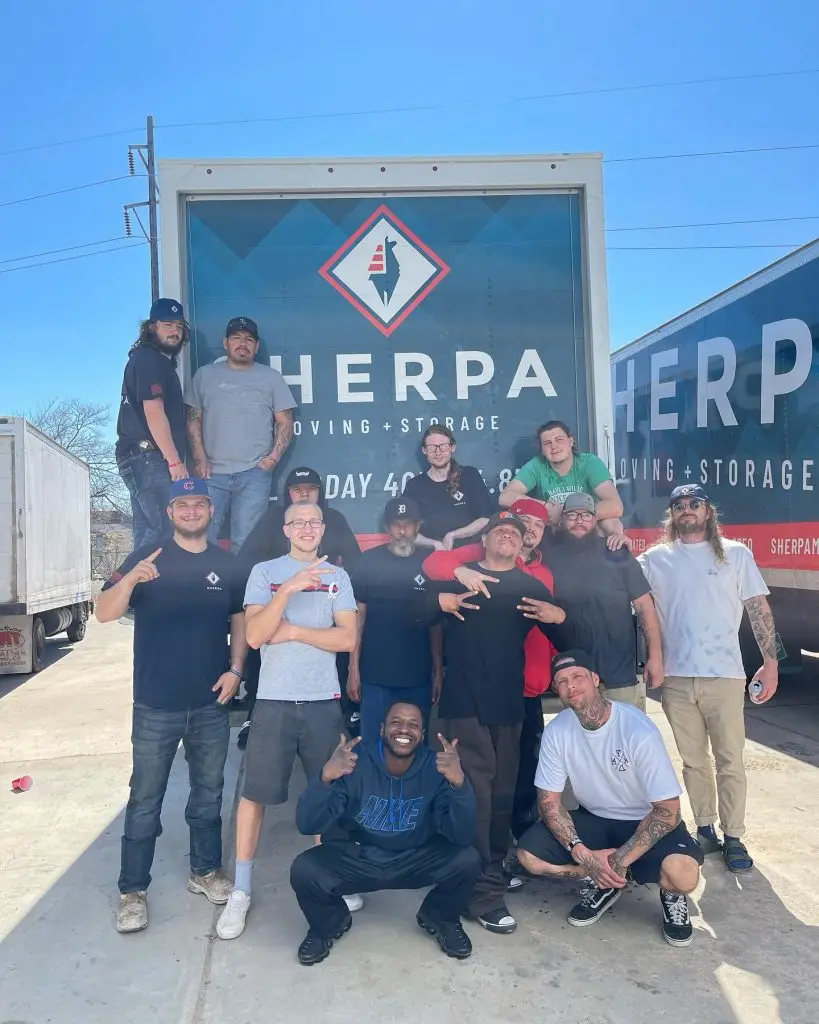 group of professional movers in front of Sherpa moving truck
